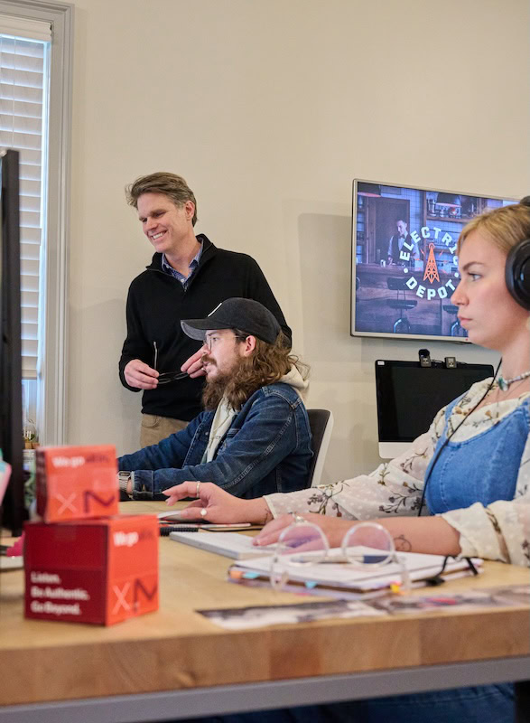 MESH employees collaborating in an open workspace