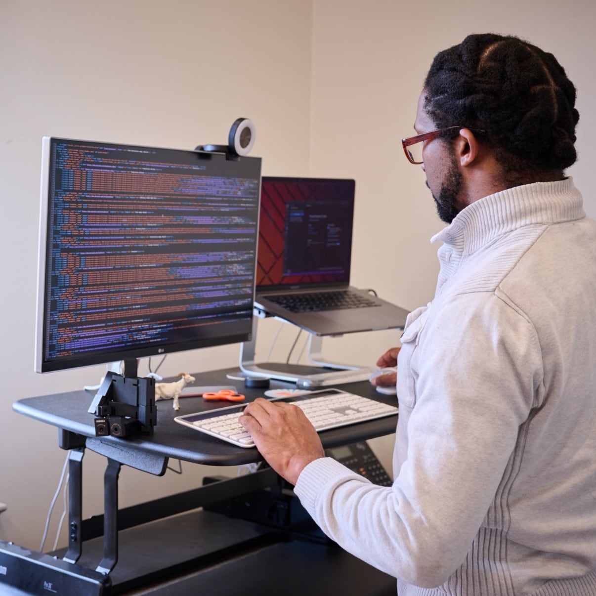 A MESH employee working at a standing desk