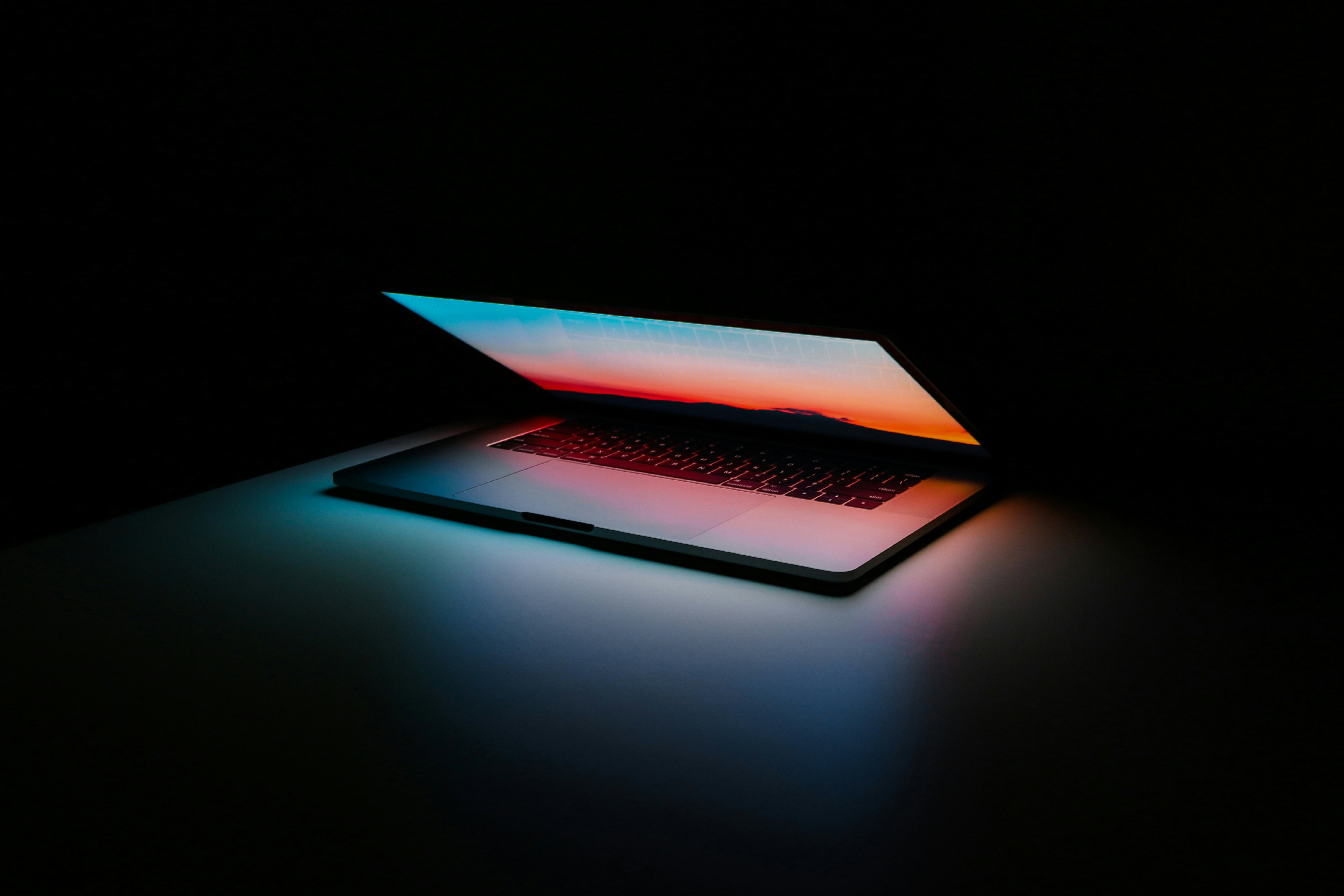 partially open laptop in a dark room