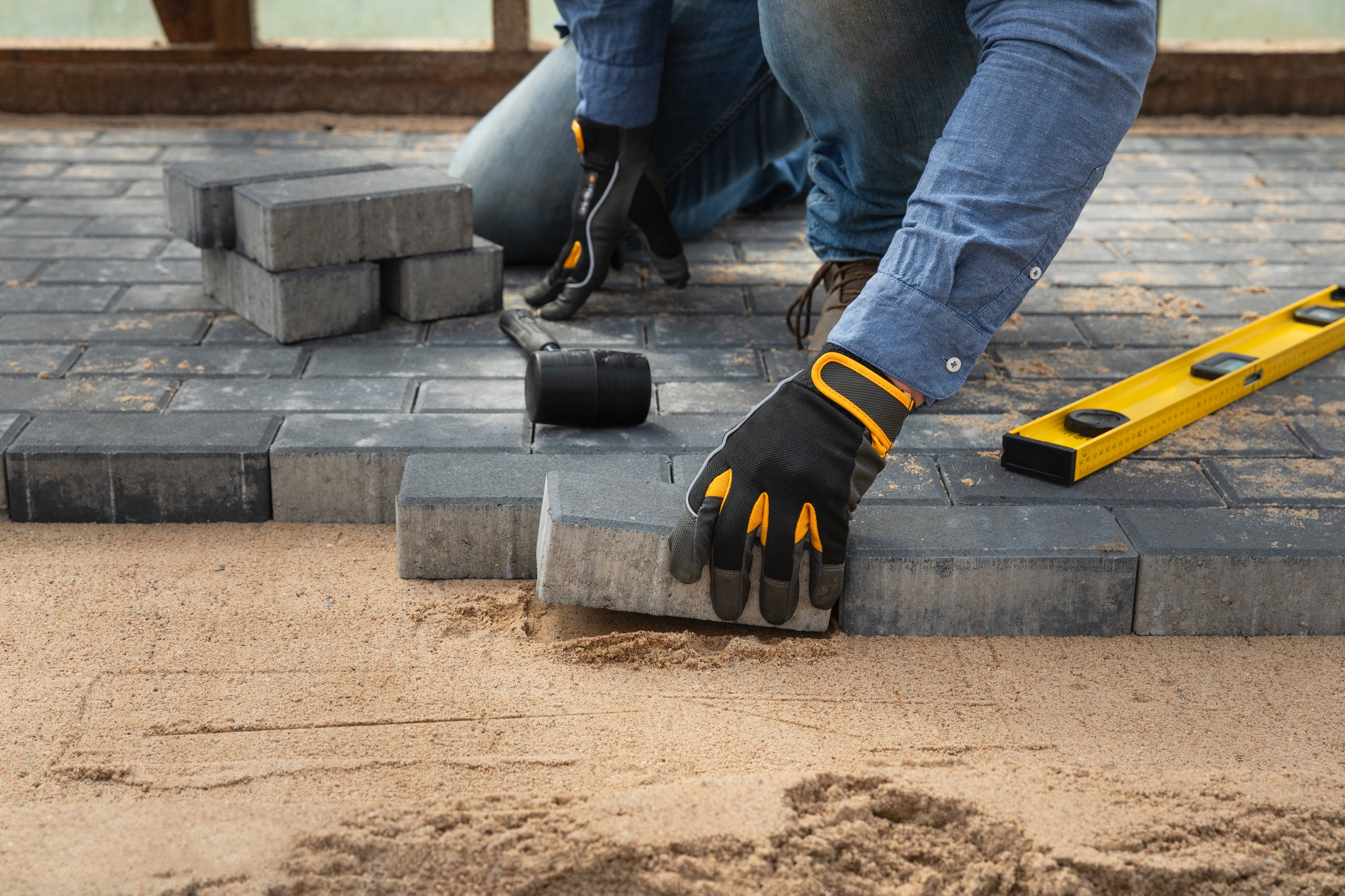 contractor constructing brick patio flooring