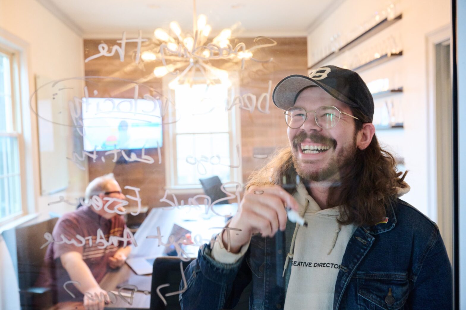 Designer writing on glass with marker 