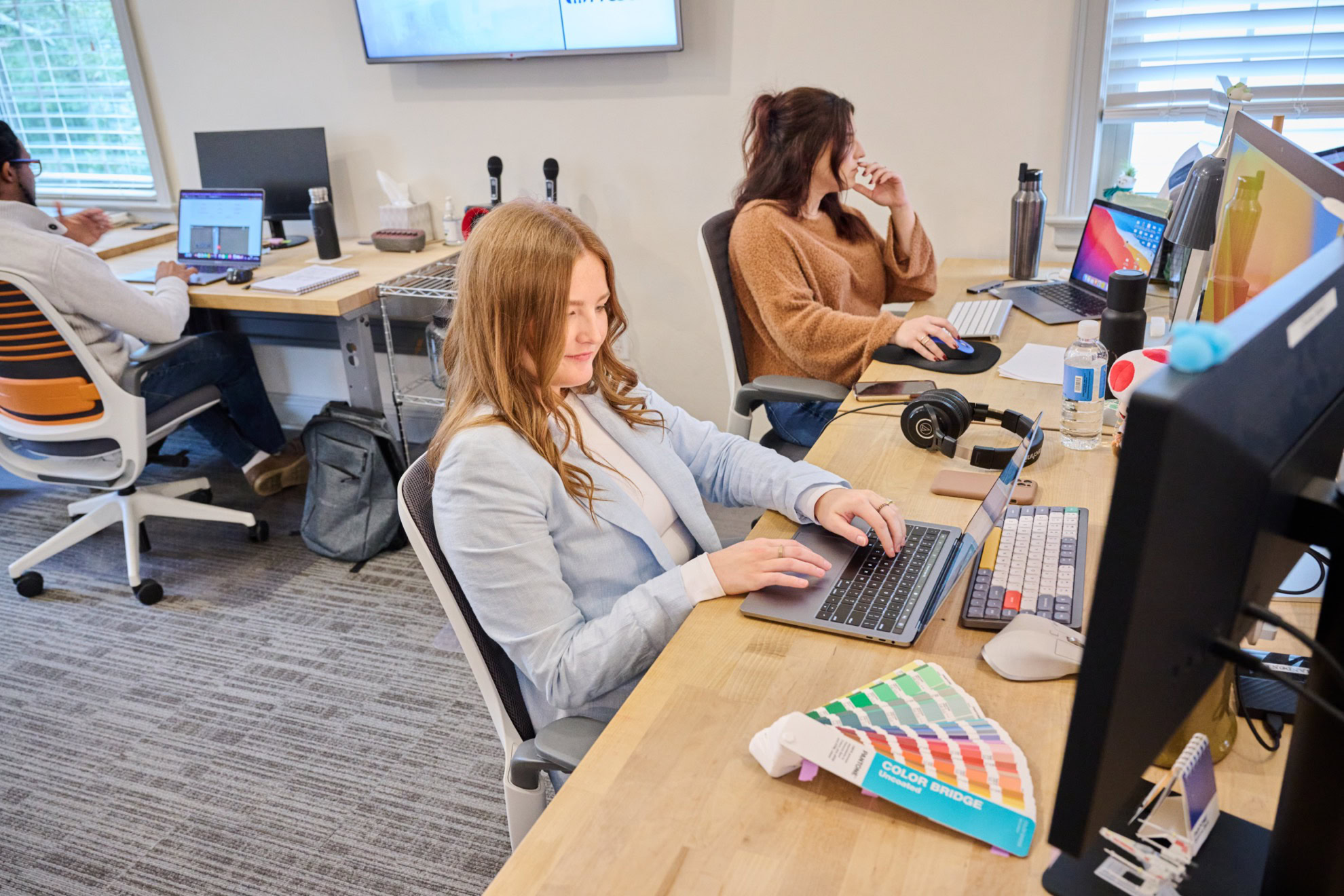 MESH employees working on their computers