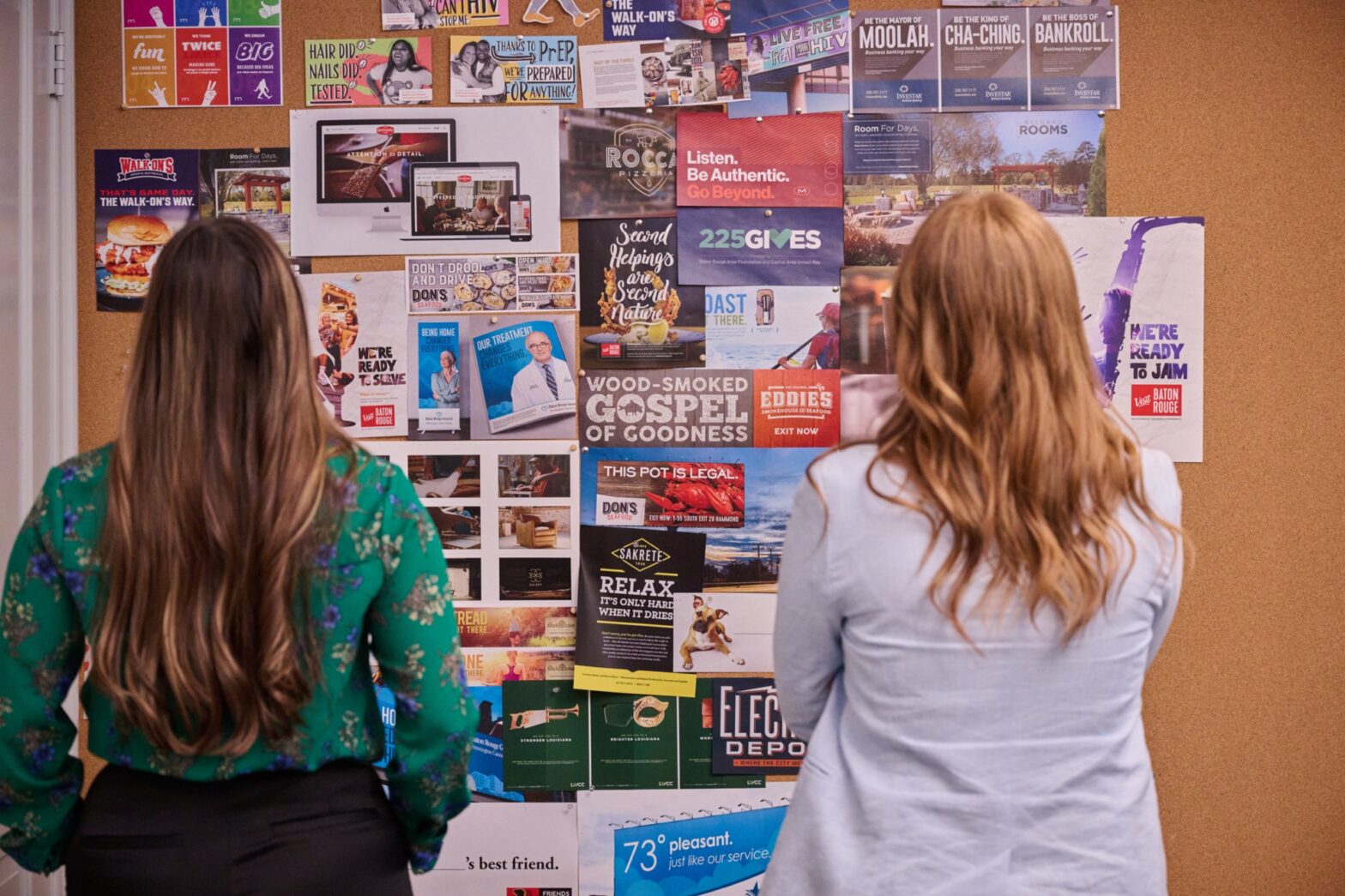 women looking at cork board