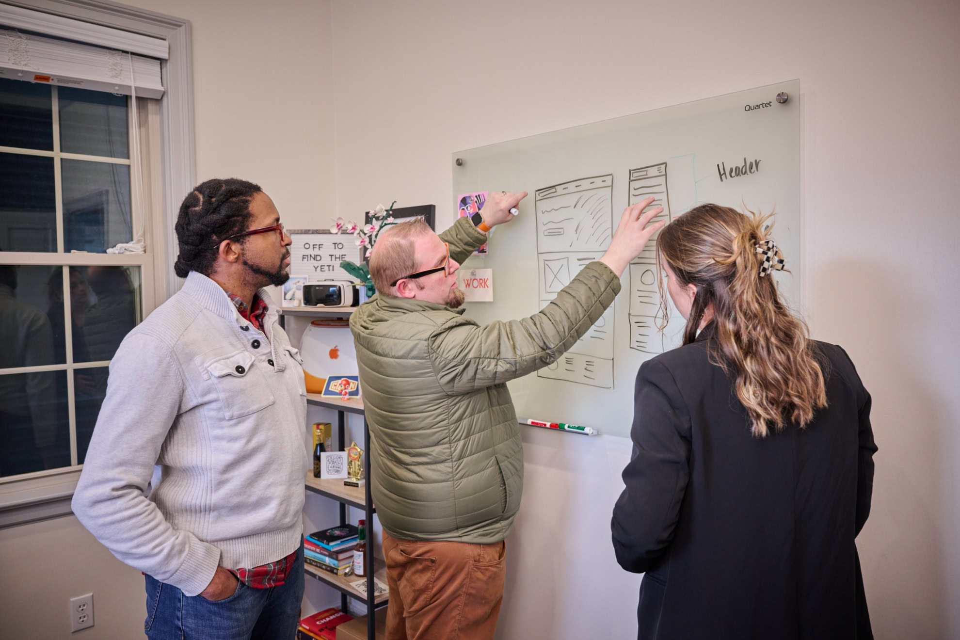 The team at MESH working next to a whiteboard